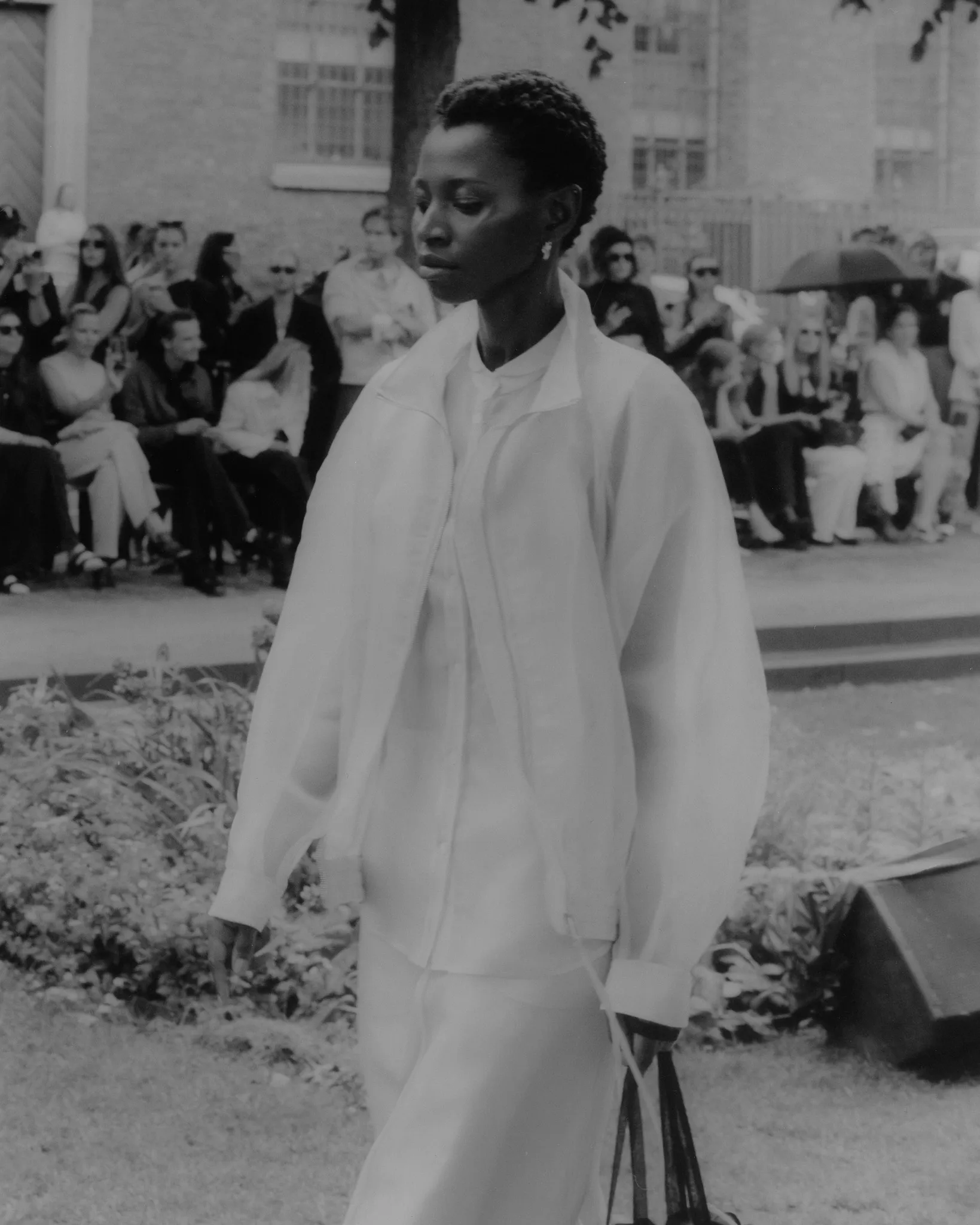 MKDT Studio SS27 – white overshirt and relaxed trousers, hand-printed film photograph